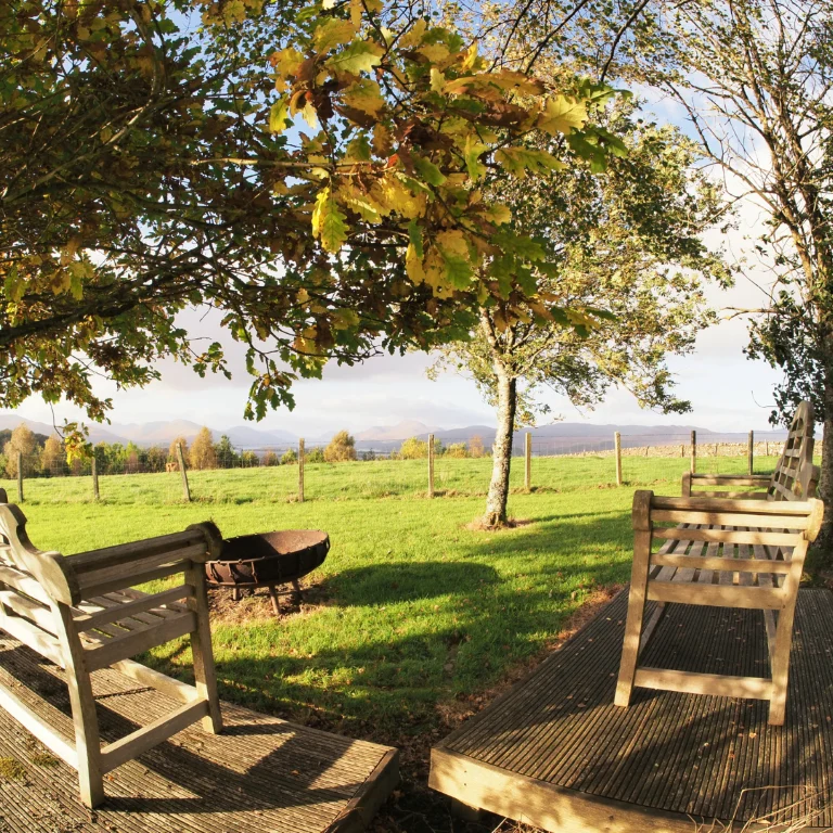Chairs arranged around an outdoor firepit at Ardoch
