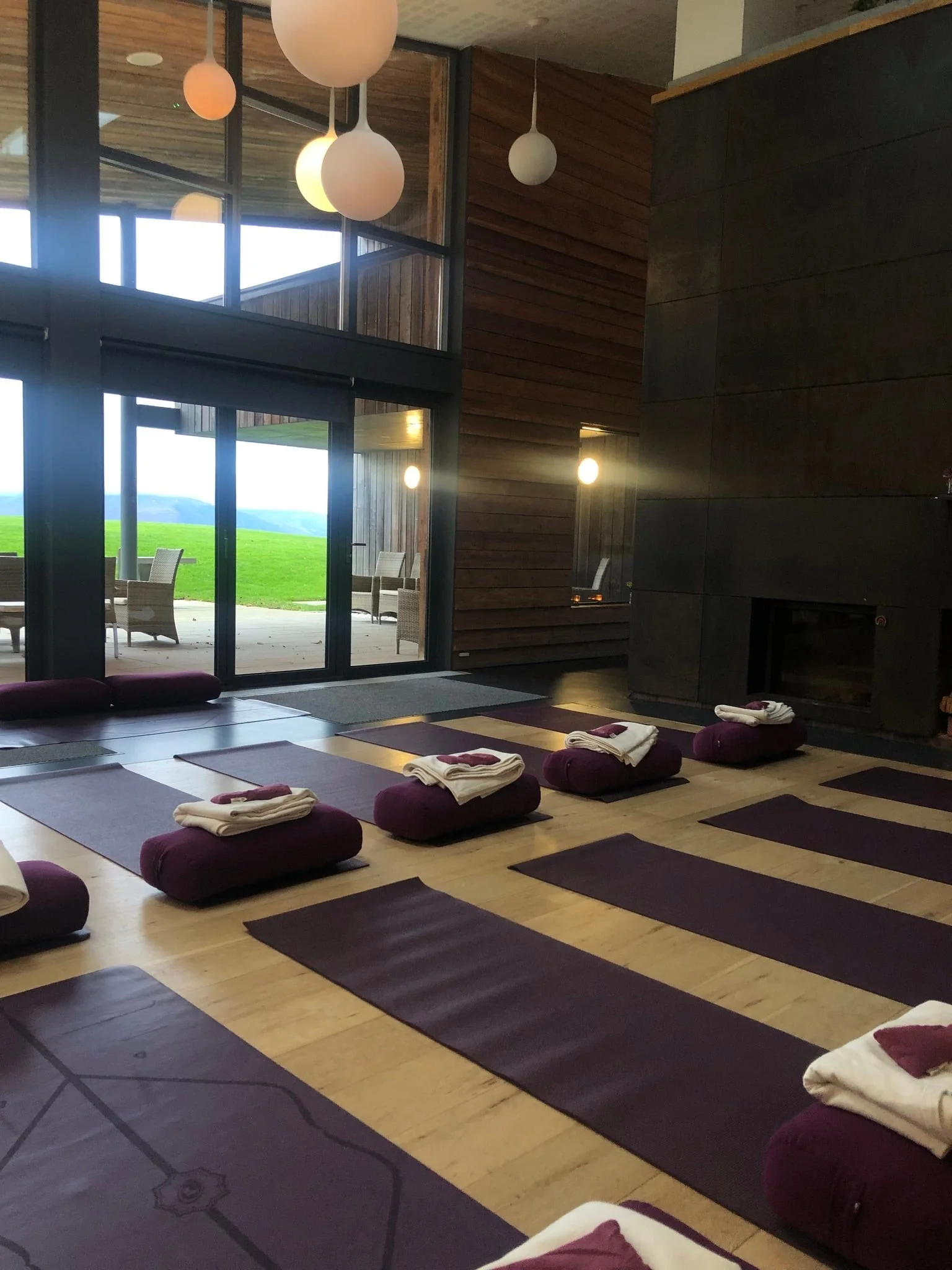Women practising yoga at Ardoch Estate in a bright room overlooking the Scottish landscape